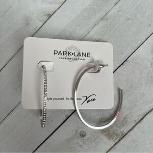 Silver and crystal oval hoop earrings.